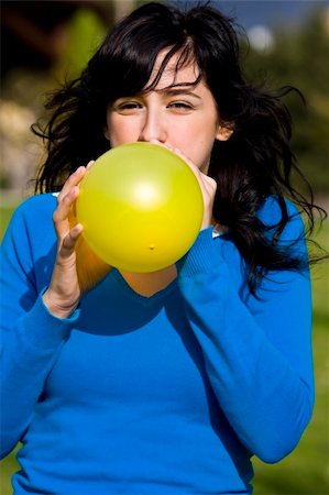 Teen inflating yellow balloon Stock Photo - Budget Royalty-Free & Subscription, Code: 400-04504428
