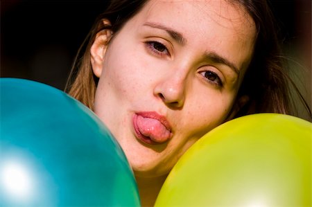 Cute girl between two colored balloons Stock Photo - Budget Royalty-Free & Subscription, Code: 400-04504430