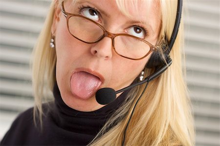simsearch:400-03933798,k - Goofy businesswoman talks on her phone headset. Stock Photo - Budget Royalty-Free & Subscription, Code: 400-04507390