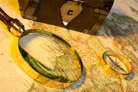 Magnifying glass, chest, compass, and map with antique look Stock Photo - Budget Royalty-Free & Subscription, Code: 400-04509122