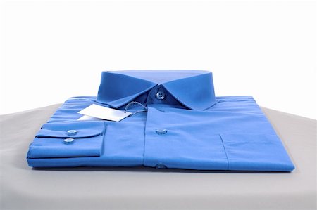 new blue man shirt on grey podium, close-up, isolated on white Stock Photo - Budget Royalty-Free & Subscription, Code: 400-04501666