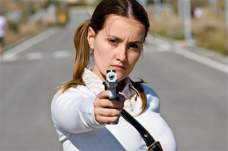 simsearch:400-05064616,k - Scholar girl pointing at camera with gun Photographie de stock - Aubaine LD & Abonnement, Code: 400-04502558