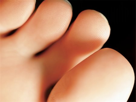 Macro and extreme shallow depth of field image of the bottom of a females toes. Foto de stock - Super Valor sin royalties y Suscripción, Código: 400-04502723