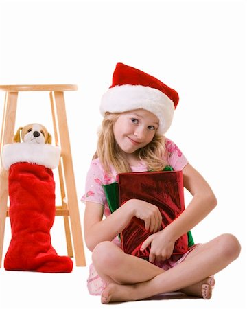 cute little eight year old girl sitting on floor holding red wrapped christmas presents Stock Photo - Budget Royalty-Free & Subscription, Code: 400-04503226