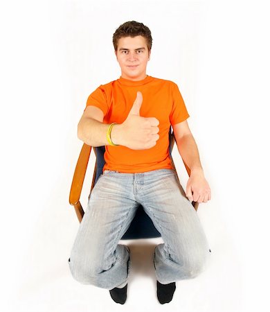 simsearch:400-04586134,k - young man in orange t-shirt sitting and showing OK Stock Photo - Budget Royalty-Free & Subscription, Code: 400-04503522