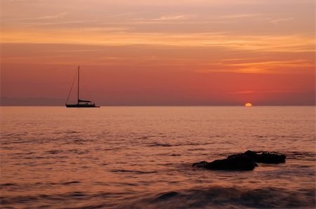 simsearch:400-04377093,k - Sailing boat silhouette and sunrise - sun is just being born from the sea Stock Photo - Budget Royalty-Free & Subscription, Code: 400-04515944