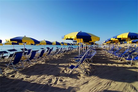 simsearch:400-07553490,k - Empty beach with umbrellas and sea shortly after the sunrise Stock Photo - Budget Royalty-Free & Subscription, Code: 400-04516005