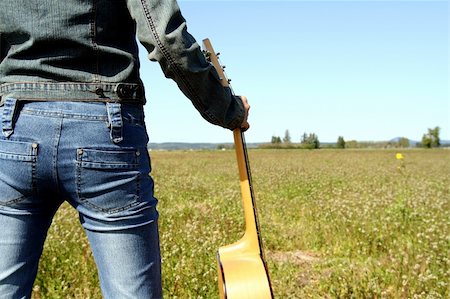 silense (artist) - A woman holding a guitar looking at an empty field Stock Photo - Budget Royalty-Free & Subscription, Code: 400-04518361