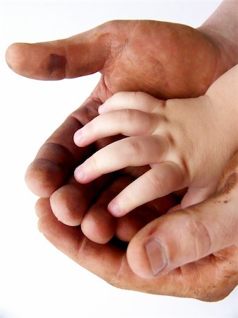 Image of large hands darkened with grease, holding a single small, clean hand. White background.  Vertical orientation. Stock Photo - Budget Royalty-Free & Subscription, Code: 400-04518580