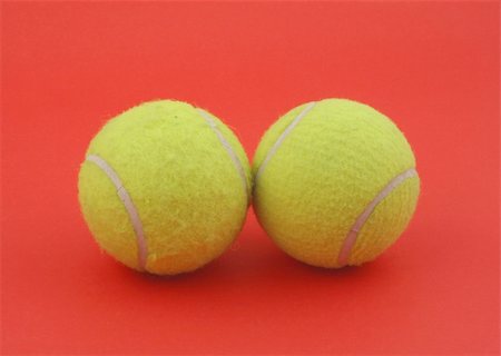 simsearch:400-04833689,k - two tennis balls on red Stock Photo - Budget Royalty-Free & Subscription, Code: 400-04524336