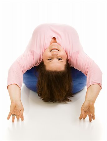 fitness   mature woman - Beautiful full figured model upside down on a pilates ball.  White background. Stock Photo - Budget Royalty-Free & Subscription, Code: 400-04526292