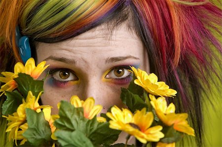 simsearch:400-04016564,k - Pretty young woman peeks out from behind plastic flowers. Stock Photo - Budget Royalty-Free & Subscription, Code: 400-04520702