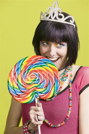simsearch:400-04016564,k - Pretty young woman takes a bite from a large lollipop Stock Photo - Budget Royalty-Free & Subscription, Code: 400-04520741