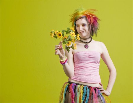 simsearch:400-04016564,k - Pretty young woman with colorful punk clothes considers plastic flowers. Stock Photo - Budget Royalty-Free & Subscription, Code: 400-04520921