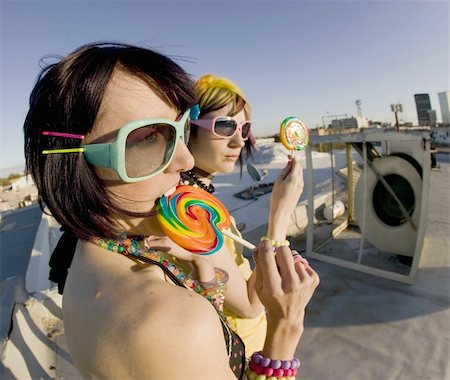 simsearch:400-04016564,k - Fisheye shot of girls in brightly colored clothing on a roof with sunglasses and lollipops Stock Photo - Budget Royalty-Free & Subscription, Code: 400-04520922