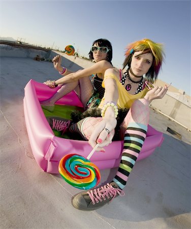 simsearch:400-04016564,k - Fisheye shot of girls in brightly colored clothing in a plastic pool on a roof with lollipops Stock Photo - Budget Royalty-Free & Subscription, Code: 400-04520923