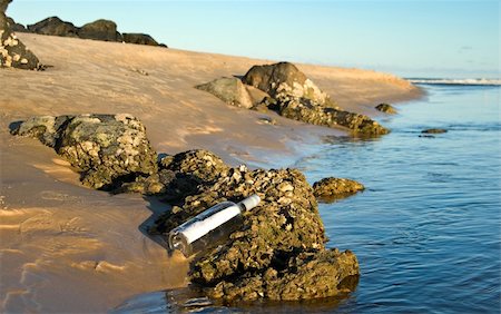 simsearch:700-02080402,k - a message in a bottle lays in the rocks Stock Photo - Budget Royalty-Free & Subscription, Code: 400-04521993