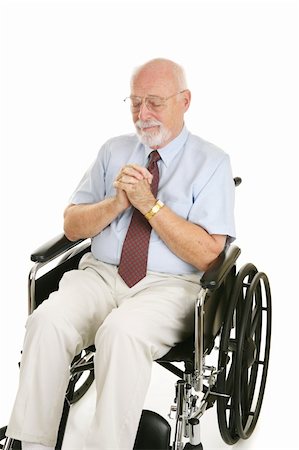 Senior man in wheelchair prays to recover his health.  Isolated on white. Stock Photo - Budget Royalty-Free & Subscription, Code: 400-04522217