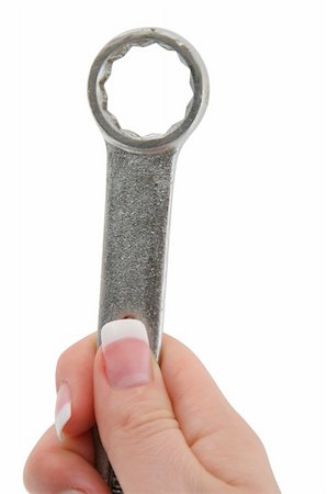 finger holding a key - female hand holding wrench tool Stock Photo - Budget Royalty-Free & Subscription, Code: 400-04522308