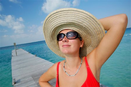 simsearch:400-03950469,k - One of a large series. Woman in red bikini sunbathing on a tropical jetty Stock Photo - Budget Royalty-Free & Subscription, Code: 400-04523020