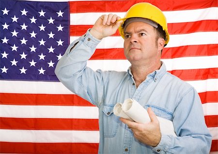 Construction worker with blueprints tipping his hardhat to the American flag.  Photographed in front of the flag, not a composite image. Stock Photo - Budget Royalty-Free & Subscription, Code: 400-04523339