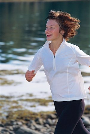 simsearch:400-04535435,k - Young woman running along water's edge Stock Photo - Budget Royalty-Free & Subscription, Code: 400-04535452