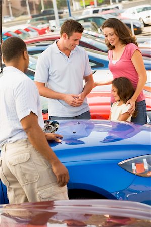 family car dealer - Family choosing new car on lot Stock Photo - Budget Royalty-Free & Subscription, Code: 400-04536081