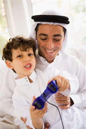 simsearch:400-05751526,k - A Middle Eastern father and son playing a video game together Stock Photo - Budget Royalty-Free & Subscription, Code: 400-04536695