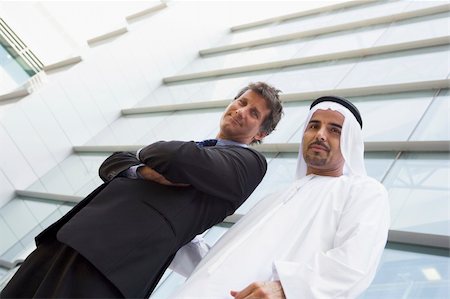 A Middle Eastern businessman and a Caucasian businessman smiling Stock Photo - Budget Royalty-Free & Subscription, Code: 400-04536828