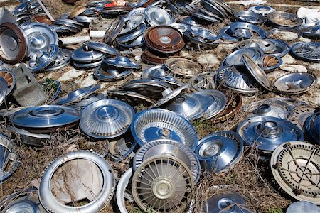 simsearch:694-03328729,k - Old metal hubcaps strewn across the ground. Stock Photo - Budget Royalty-Free & Subscription, Code: 400-04538091