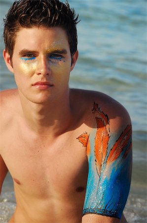 simsearch:400-03944633,k - Portrait of young handsome model on the beach with artistic bodypaint drawing Stock Photo - Budget Royalty-Free & Subscription, Code: 400-04539820
