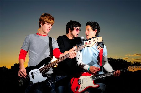 simsearch:400-04026083,k - Portrait of three trendy teenagers playing music outdoors Stock Photo - Budget Royalty-Free & Subscription, Code: 400-04539822