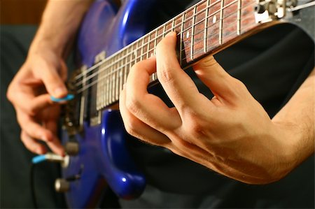picture of the blue playing a instruments - man play solo on blue guitar Stock Photo - Budget Royalty-Free & Subscription, Code: 400-04531395