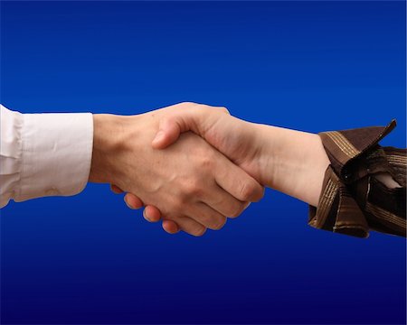 equality background hands - handshake on turn blue background Stock Photo - Budget Royalty-Free & Subscription, Code: 400-04533770