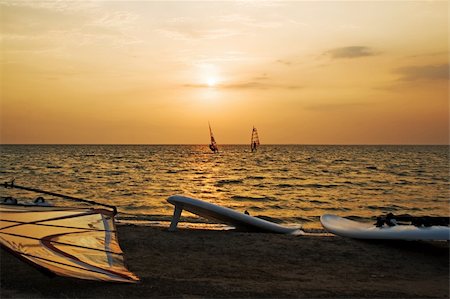 simsearch:400-03992760,k - Silhouette of a two windsurfer on a gulf on a sunset Stock Photo - Budget Royalty-Free & Subscription, Code: 400-04554311