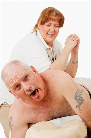 Humorous photo of a man surprised by a painful massage from an overly enthusiastic masseuse. Stock Photo - Budget Royalty-Free & Subscription, Code: 400-04554870
