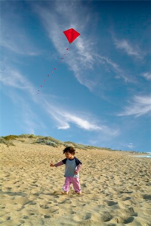 pictures of boy fly kites in the sky - boy on beach playing with a red kite Stock Photo - Budget Royalty-Free & Subscription, Code: 400-04556336