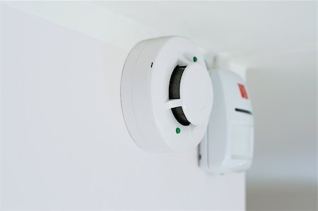 sensor - smoke detector and alarm mounted on a wall, shallow DOF Stock Photo - Budget Royalty-Free & Subscription, Code: 400-04556431