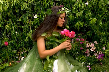 Mother Nature looking upon some of her many beautiful creations in her enchanted garden  This indoor studio shoot is a compilation of many fresh flowers, grass, tree branches and bushes. Stock Photo - Budget Royalty-Free & Subscription, Code: 400-04559011