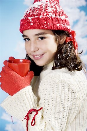 little girl in christmas colors with a red cup of something hot Stock Photo - Budget Royalty-Free & Subscription, Code: 400-04551721