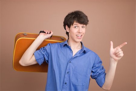 Young traveller with suitcase isolated on beige background Photographie de stock - Aubaine LD & Abonnement, Code: 400-04553755