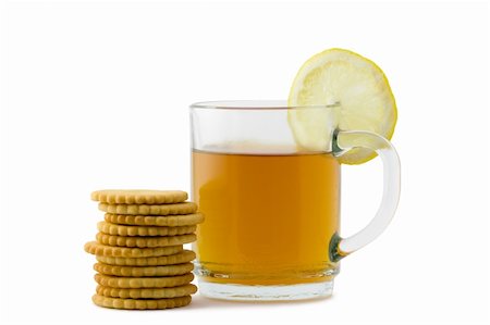 simsearch:400-04273561,k - A cup of hot tea with a slice of lemon and crackers over white background Stock Photo - Budget Royalty-Free & Subscription, Code: 400-04564527