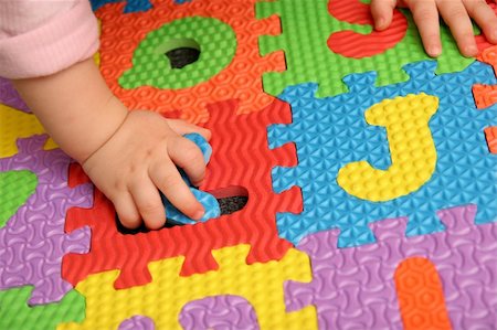 simsearch:400-04331637,k - child playing multi colored alphabet puzzle Stock Photo - Budget Royalty-Free & Subscription, Code: 400-04566867