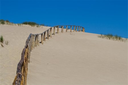 Wooden fence in sand dunes. Curonian Spit is on the UNESCO's World Heritage List in Lithuania Stock Photo - Budget Royalty-Free & Subscription, Code: 400-04568920