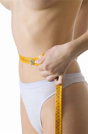 close up of a slim female body measuring her waist Stock Photo - Budget Royalty-Free & Subscription, Code: 400-04560884