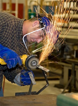 Student welder in metal shop, using a grinder to smooth his creation.  All work depicted is accurate and in accordance with industry safety and code regulations. Stock Photo - Budget Royalty-Free & Subscription, Code: 400-04574818