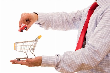 simsearch:400-04321973,k - Shopping concept - Hand putting a car on a trolley shop Stock Photo - Budget Royalty-Free & Subscription, Code: 400-04577237
