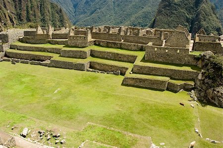 Machu Picchu  is a pre-Columbian Inca site located 2,400 meters (7,875 ft) above sea level. It is situated on a mountain ridge above the Urubamba Valley in Peru, which is 80 km (50 mi) northwest of Cusco. Often referred to as "The Lost City of the Incas", Machu Picchu is probably the most familiar symbol of the Inca Empire. Stock Photo - Budget Royalty-Free & Subscription, Code: 400-04573282
