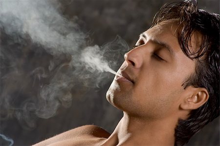 simsearch:400-06761272,k - Close-up of an intensively smoking man with heavy smoke Stock Photo - Budget Royalty-Free & Subscription, Code: 400-04584884