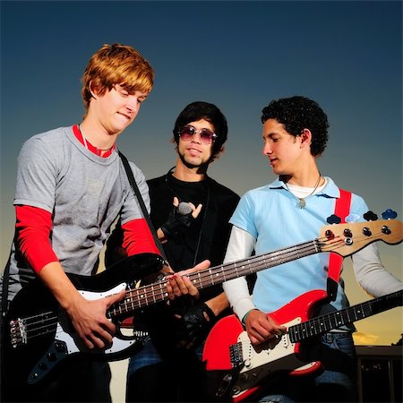 simsearch:400-04026083,k - Portrait of young trendy musicians playing electric guitars Stock Photo - Budget Royalty-Free & Subscription, Code: 400-04587436